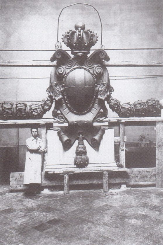 Roberto de Cupis fotografato nel suo studio con lo Stemma dei Savoia realizzato per la nuova stazione ferroviaria di Forlì, 1927. Proprietà privata.